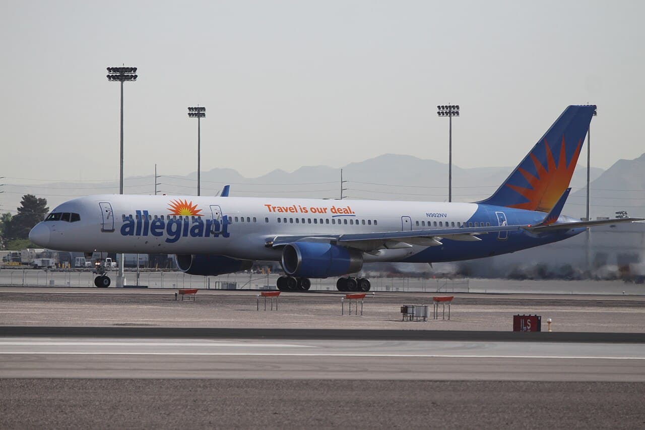 Allegiant Air aircraft on tarmac with clear skies at a leisure destination airport