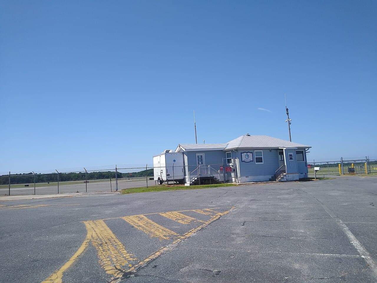 Snowplow clearing runway at an airport during winter storm