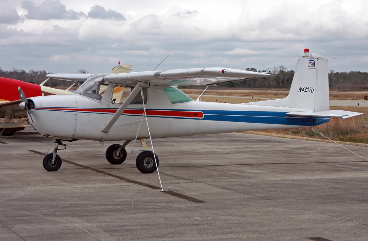 General aviation aircraft on taxiway with residential houses under construction nearby at a regional airport