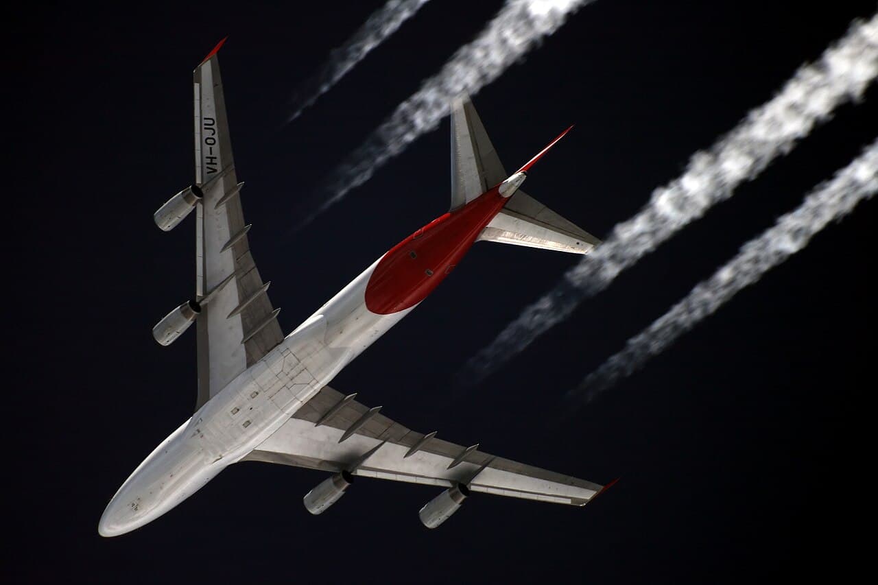 Boeing 747 aircraft parked at airport gate under clear daylight