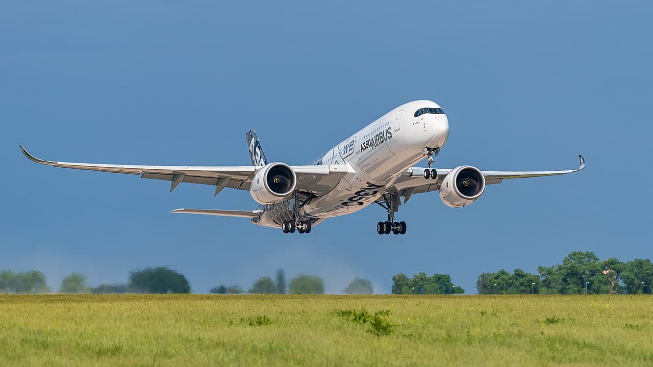 Airbus A350-900ULR taxiing at sunrise showing premium economy cabin windows