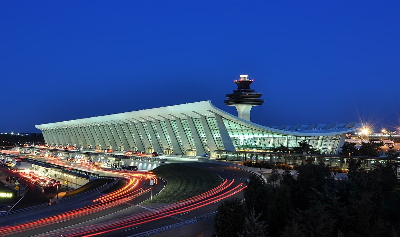 An aerial view of Washington Dulles International Airport showing terminals and concourses under construction.