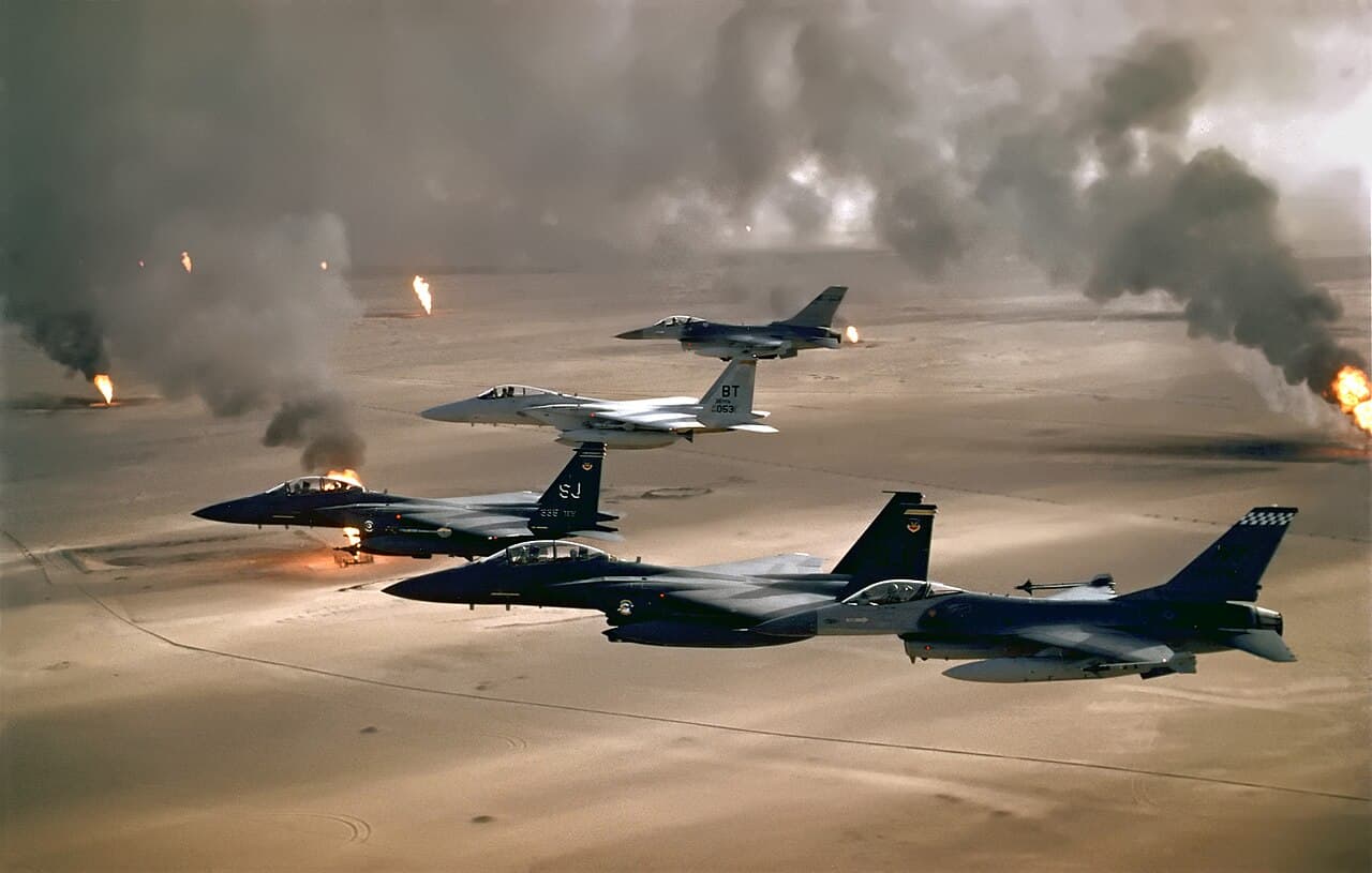 F-15 fighter jets taxiing on a military airbase runway under clear skies