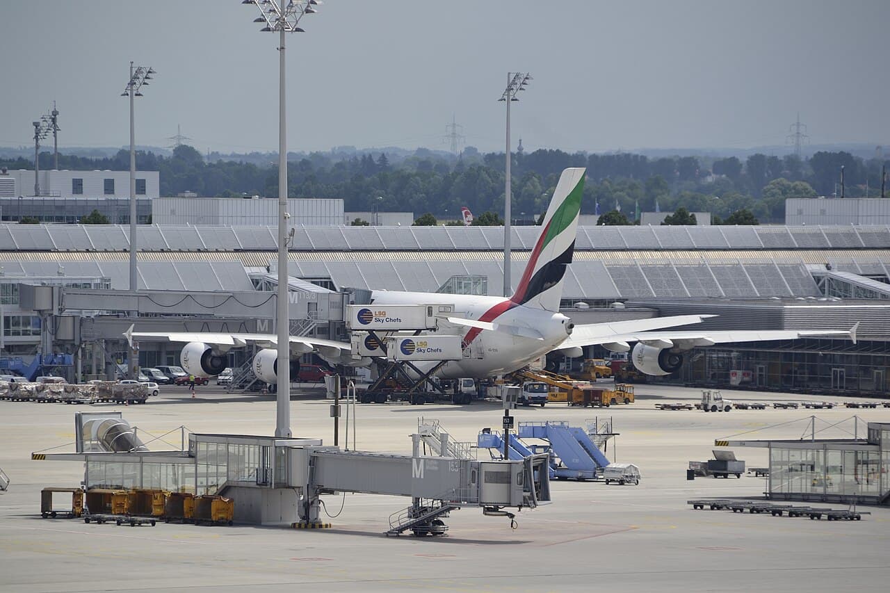 Boeing 787-9 on runway after a takeoff incident with visible dust and emergency response